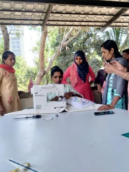 Our instructor provides personalized guidance on using a sewing machine during a beginner class, ensuring every student feels confident.