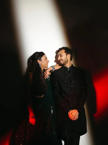 A cool, edgy portrait using red and white light to create a modern and stylish look for the couple's sangeet.
