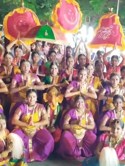 A large group photo from the Pallakki Utsava, with dancers holding traditional umbrellas. These street processions are a visual spectacle and a unique performance experience.
