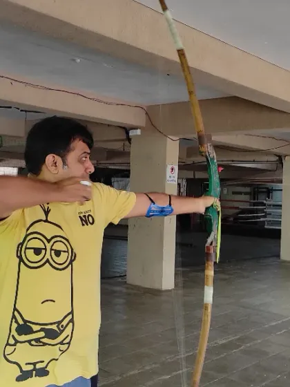 It's never too late to learn a new skill. This adult student is concentrating on his shot, showing that archery is a fantastic sport for people of all ages to build focus and patience.