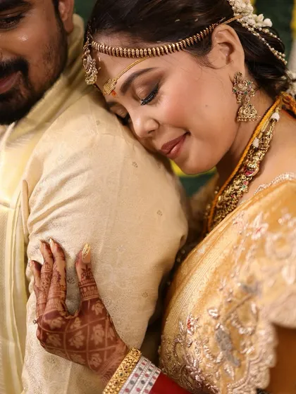An emotional moment captured, with the bride's elegant updo visible from the side.