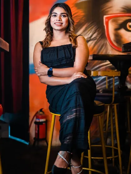 A guest posing on a bar stool against the graffiti wall.