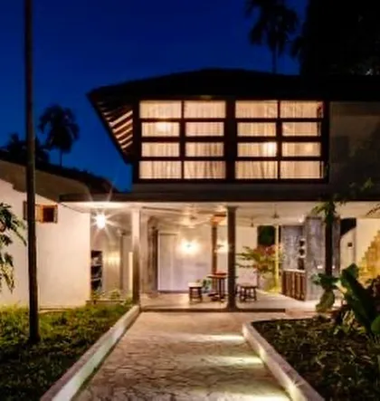 The entrance foyer of the main villa at night, warmly lit to create a welcoming ambiance.