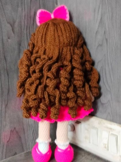 Look at the back of this doll with her beautiful, long curly hair. I use soft yarn to make the hair, so it is nice to touch and style.