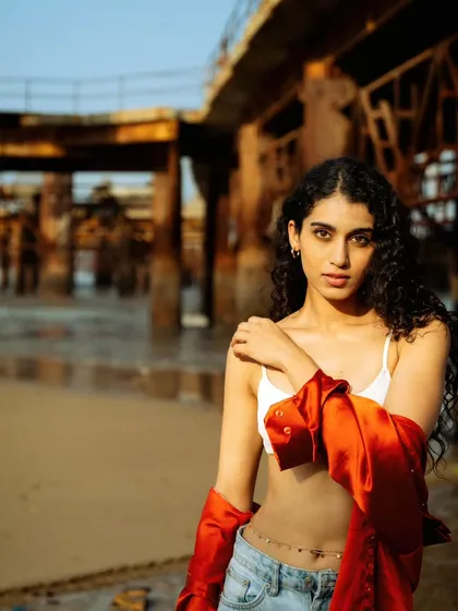 A classic portrait pose with the industrial pier in the background. The contrast between the soft subject and the hard structure is a theme I love to explore.