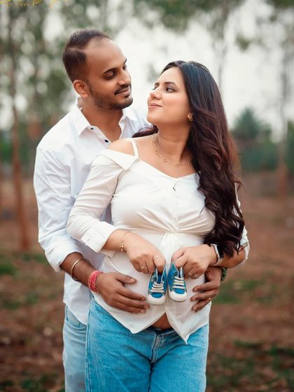 A cute and casual outdoor shot with the baby's first shoes. Using props like this is a lovely way to symbolize your growing family.