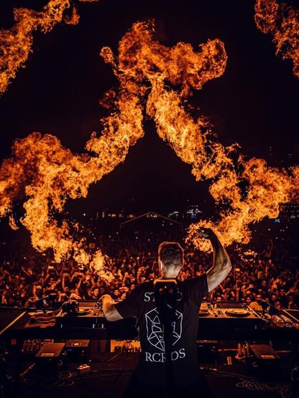 My shows are known for their intense pyrotechnics. Here, Martin Garrix commands the stage as pillars of fire erupt behind him, creating a powerful and unforgettable visual.
