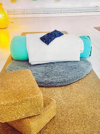 This is the setup for a Restorative or Yin yoga session. Using props like bolsters, blocks, and blankets allows us to hold poses for longer, releasing deep-seated tension and calming the nervous system. It's all about supported relaxation.