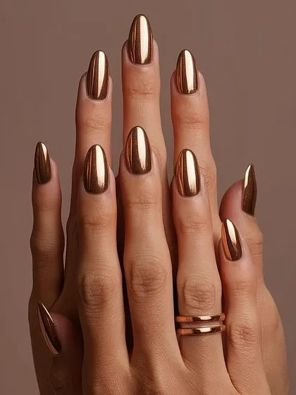 They call me the 'queen of bling' for a reason. This full set of almond-shaped chrome nails in a brilliant liquid gold finish is the ultimate statement in luxury. It's a bold, high-impact look that I love creating for clients who aren't afraid to stand out.