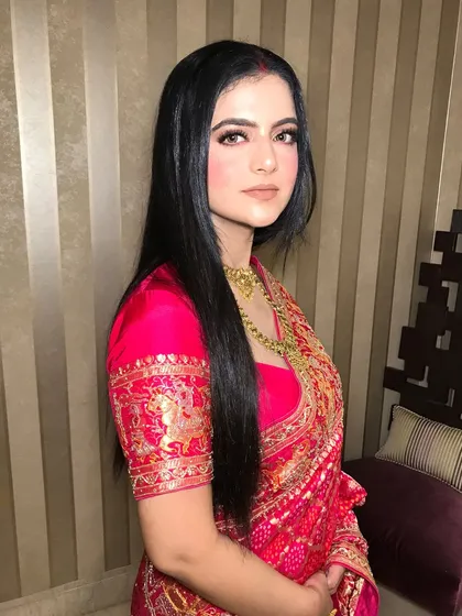 A frontal view, her sleek hair and classic jewelry creating a sophisticated look.