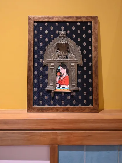 The framed Mughal miniature Prabhavali, a perfect example of how we can blend different art historical styles to create unique decor. The vintage brass frame adds a layer of history and character.