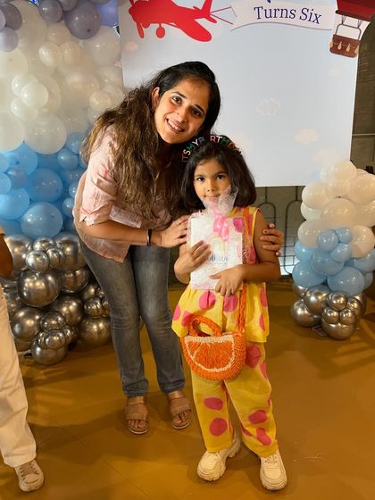 This little one is all smiles at her hot air balloon-themed sixth birthday party. It's a privilege to create these lovely memories with them.