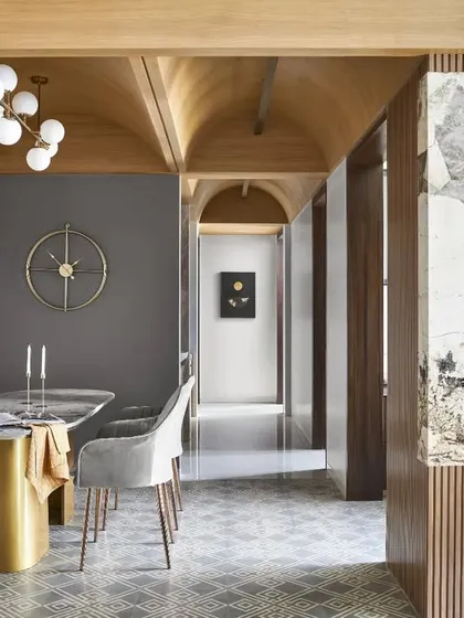 The vaulted wooden ceiling in this home is a key architectural feature that adds height, warmth, and character. It demonstrates how I work with a space's structure to create dramatic and inviting interiors.