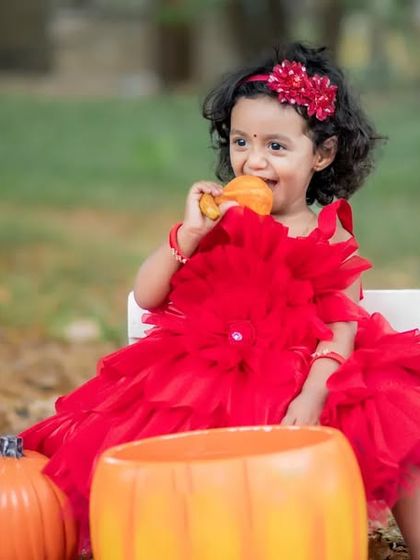 Cuteness overload. Enjoying a little snack during her autumn-themed outdoor photoshoot.