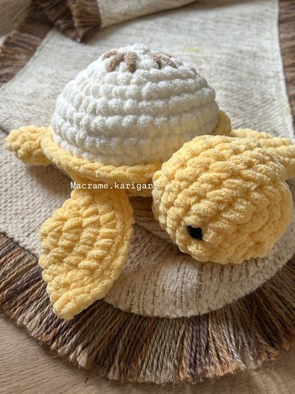 A close-up of our lemon-themed chunky yarn turtle. The plush yarn gives it a wonderful texture, making it a perfect sensory toy for kids.