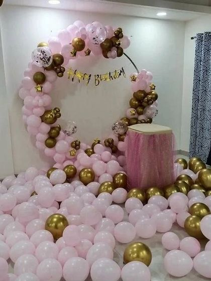 Another view of the pink and gold balloon room decoration, showing the sheer volume of balloons creating a fun atmosphere.