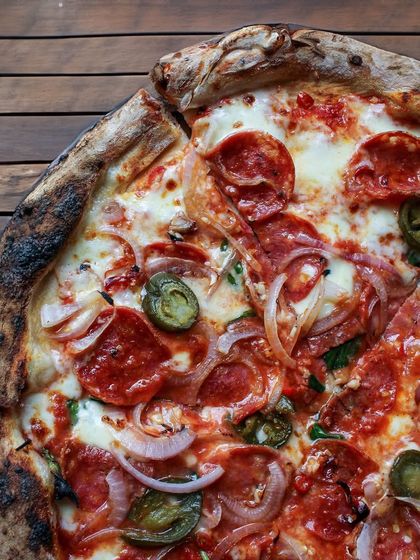 Our Diavola pizza is for those who like it hot. It's loaded with salty pepperoni, three kinds of chili for complex heat, and balanced with the sweetness of sliced onions.