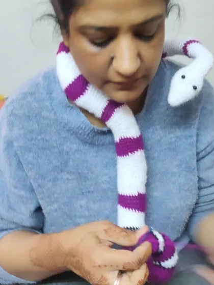 I’m not a big fan of reptiles, but I love a challenge. Here I am with a custom-ordered crochet snake. It was a fun project that pushed me out of my comfort zone.