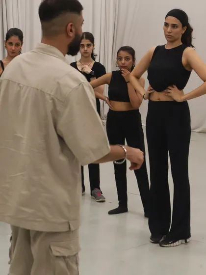 Here I am breaking down the choreography for my students before a showcase. My focus is on clear instruction and creating a supportive space where everyone feels comfortable to learn and ask questions.