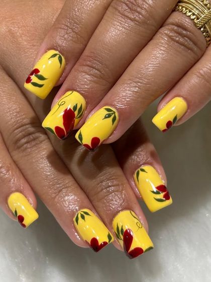 Another angle of the vibrant yellow floral nails, showing the hand-painted details.