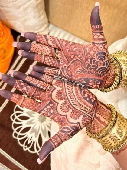 The final result is just as important as the initial design. I use high-quality, natural henna to ensure a beautiful, dark, and long-lasting stain, as you can see on these hands adorned with intricate bangles.