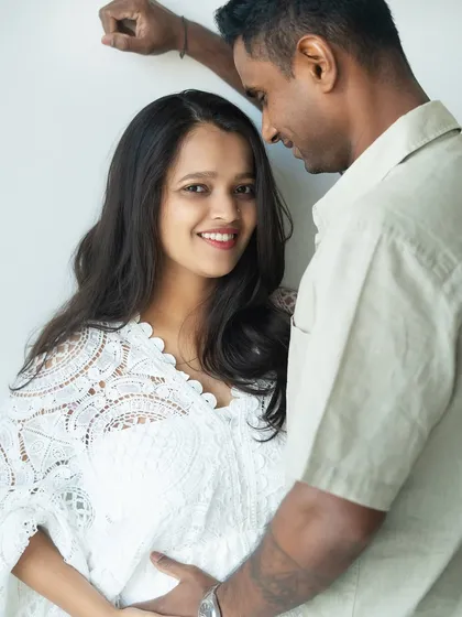 The mom-to-be's radiant smile says it all. This close-up captures the happiness and intimacy of a couple eagerly awaiting their baby girl.
