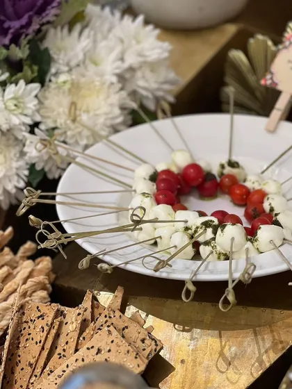 A simple yet elegant appetizer of Caprese skewers, perfect for passing around at any event. The vibrant red of the tomatoes contrasts beautifully with the white mozzarella.