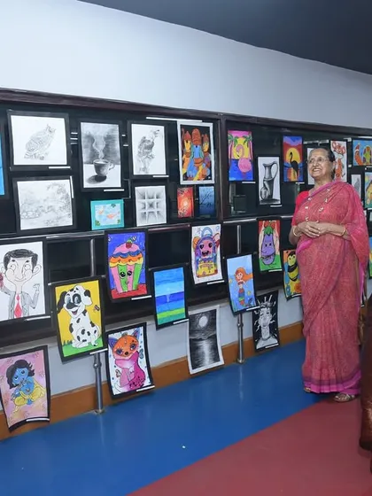 Parents and guests admiring the diverse collection of student artwork. Our exhibitions are a community event, bringing families together to celebrate the creative achievements of our students, from beginner sketches to advanced paintings.