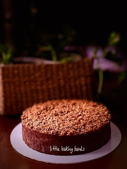 A moodier shot of the apple cinnamon chocolate cake, highlighting its simple, rustic form and crumble topping.