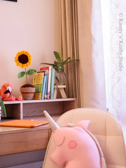 My crochet sunflower in a planter makes a wonderful desktop buddy. It's a cheerful addition to a study space, helping to make homework time a little more fun.