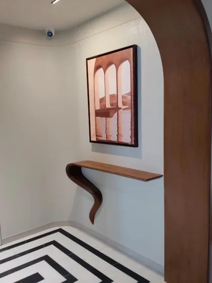 When art meets design, every corner tells a story. This entryway features a unique, sculptural console table paired with artwork, creating an immediate impression of curated style.