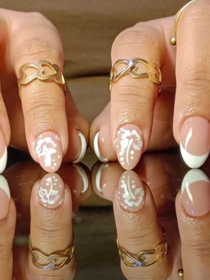 A full view of the lace-accented French manicure, showing how the detailed art complements the classic white tips.