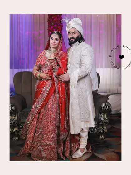 A classic, formal portrait of the bride and groom on their wedding day. Their regal outfits and poised stances create a timeless and elegant memory.