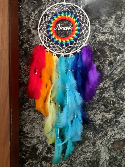 Brighten up a room and bring a smile to someone's face with our personalized rainbow dreamcatcher. We wove the name 'Ameera' into this vibrant piece, making it a magical and thoughtful gift that adds a pop of color and joy.