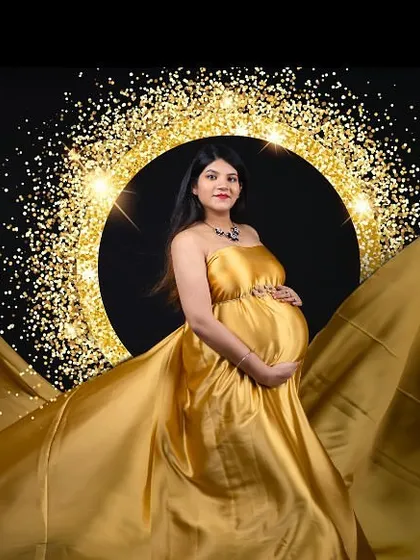 A golden goddess moment. This shot uses a flowing gold satin gown and a sparkling ring light to create a radiant and glamorous portrait against a black backdrop.
