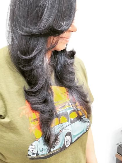 A beautiful example of a layered haircut with an outward blow-dry. This styling technique adds volume and creates soft, flowing layers that frame the face perfectly.