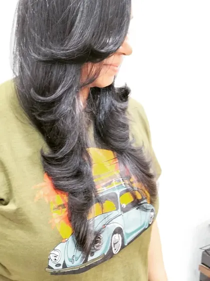A beautiful example of a layered haircut with an outward blow-dry. This styling technique adds volume and creates soft, flowing layers that frame the face perfectly.