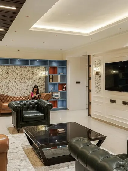 A wide shot of the living room from image 61, showing the full layout with the custom shelving and classic furniture.