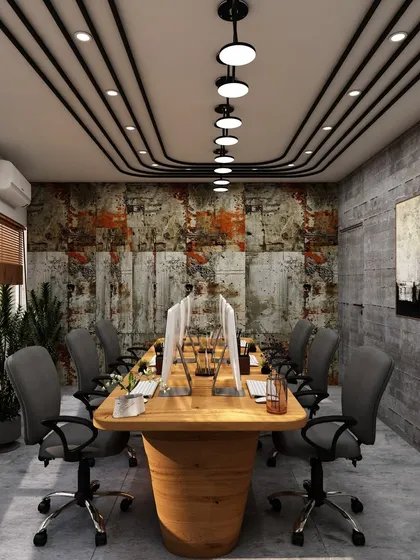 This view of the collaborative office highlights the textured accent wall, which adds depth and character to the space. The design balances raw industrial elements with refined wooden furniture.