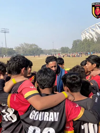 A team huddle with the coach during the Delhi Cup Soccer League.