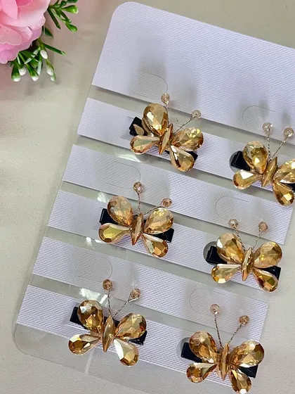 The gold version of these stone butterfly clips adds a touch of warmth and luxury to your hairstyle.