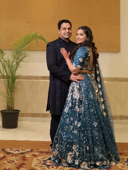 A classic portrait of the couple on their Sangeet night, elegantly dressed and perfectly complementing the sophisticated decor.