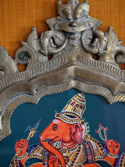 A close-up on the top of the Ganesha prabhavali, highlighting the antique craftsmanship of the arch itself, which I always aim to honor with my artwork.