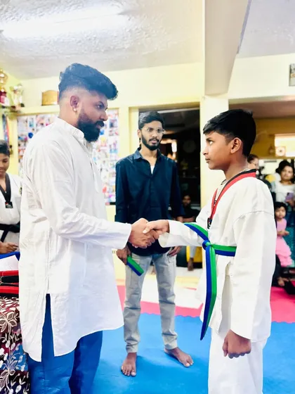 A handshake of congratulations for a newly promoted student.