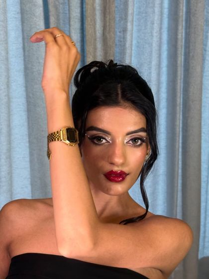 The classic red lip is always a showstopper. This high-glam look features jeweled eyeliner for an extra touch of sparkle.