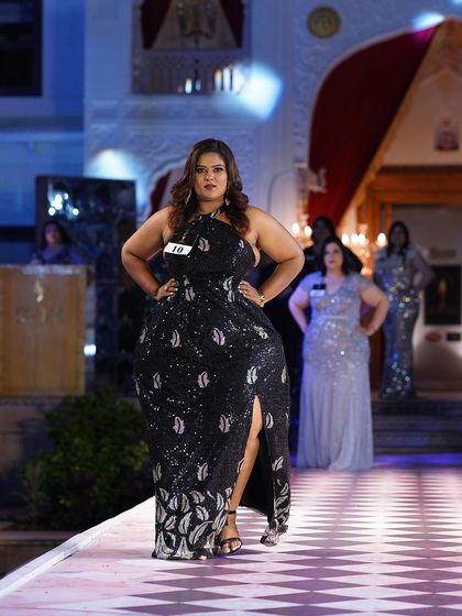 A black sequined plus-size gown with a unique leaf pattern and a daring slit. This is for the woman who loves to make a statement.
