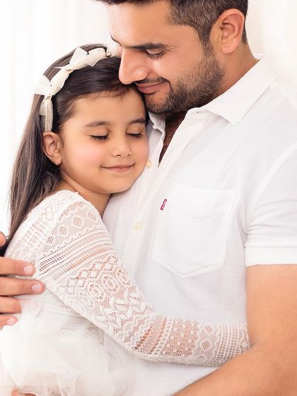 A father's love. This tender moment between a dad and his daughter is what family photography is all about.