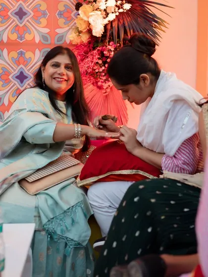 A happy mother getting her mehendi done. We ensure that every member of the family is taken care of and enjoys the festivities.