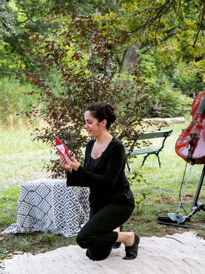 An artist interacts with a small prop during the performance. Every detail in 'Pajarillo Verde' is crafted to create a whimsical and engaging world for our young audience.