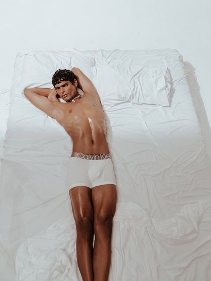 A tighter crop of the overhead shot, focusing on the upper body and the iconic waistband. This composition is designed for high impact on social media and digital platforms.